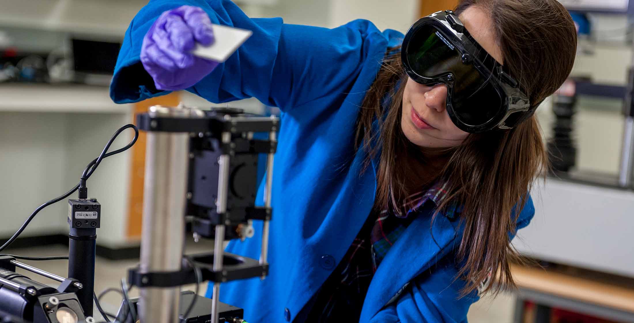 A SMART scholar looking at a sample in a lab.